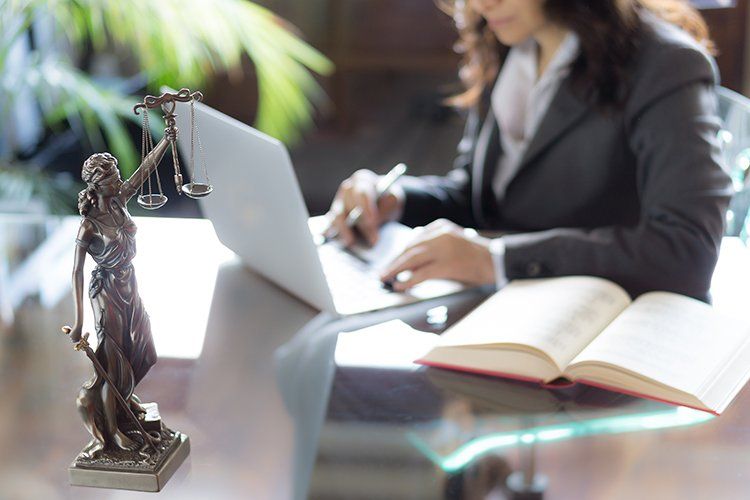 Statue of Justice and Lawyer Working ─ Grand Island, NE ─ Bradley Law Firm, PC