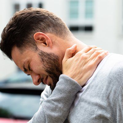 Neck Pain — Man Holding on His Neck In Cotuit, MA Neck Pain — Man Holding on His Neck In Cotuit, MA