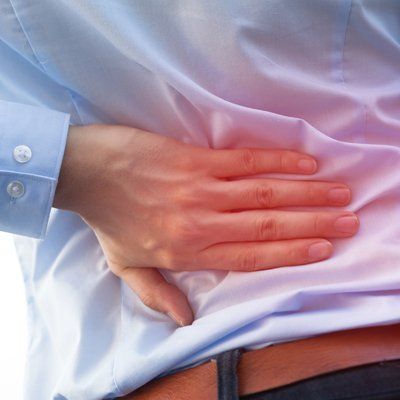 Back Pain — Man Holding on His Waist In Cotuit, MA Back Pain — Man Holding on His Waist In Cotuit, MA