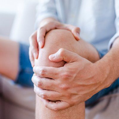 Pain in the Joints — Man Holding on His Knees In Cotuit, MA Pain in the Joints — Man Holding on His Knees In Cotuit, MA