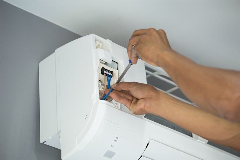Technician Installing Air Conditioning Unit — Toowoomba, QLD