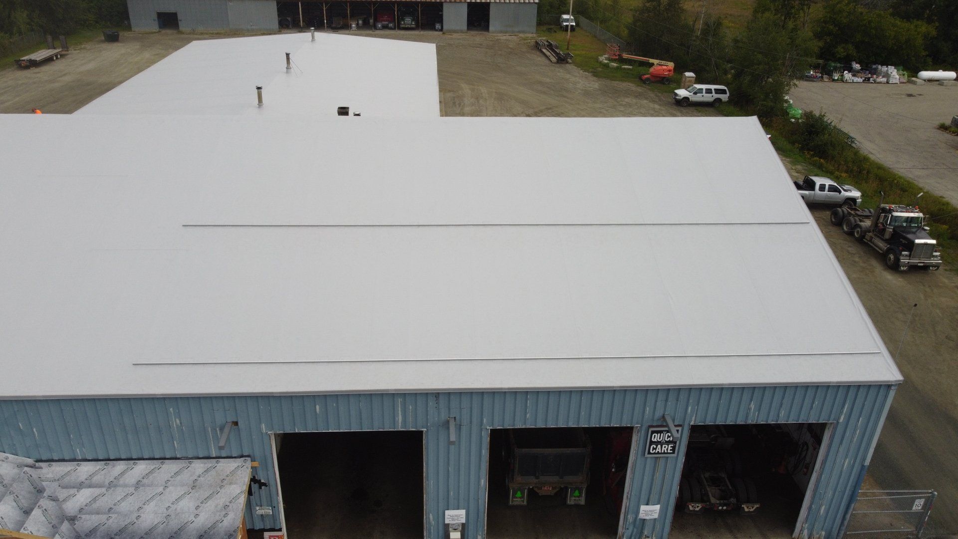 Rodd Roofing’s expert team working on a large-scale metal retrofit roofing project.
