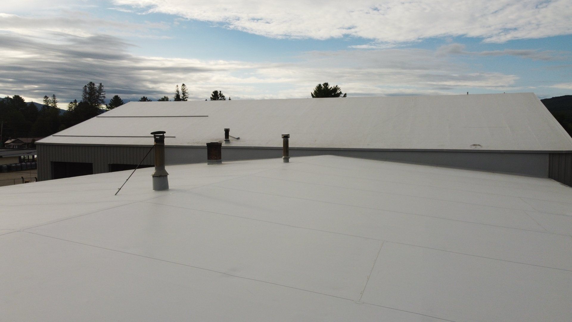 Aerial view of Rodd Roofing’s metal retrofit project on a large industrial building.
