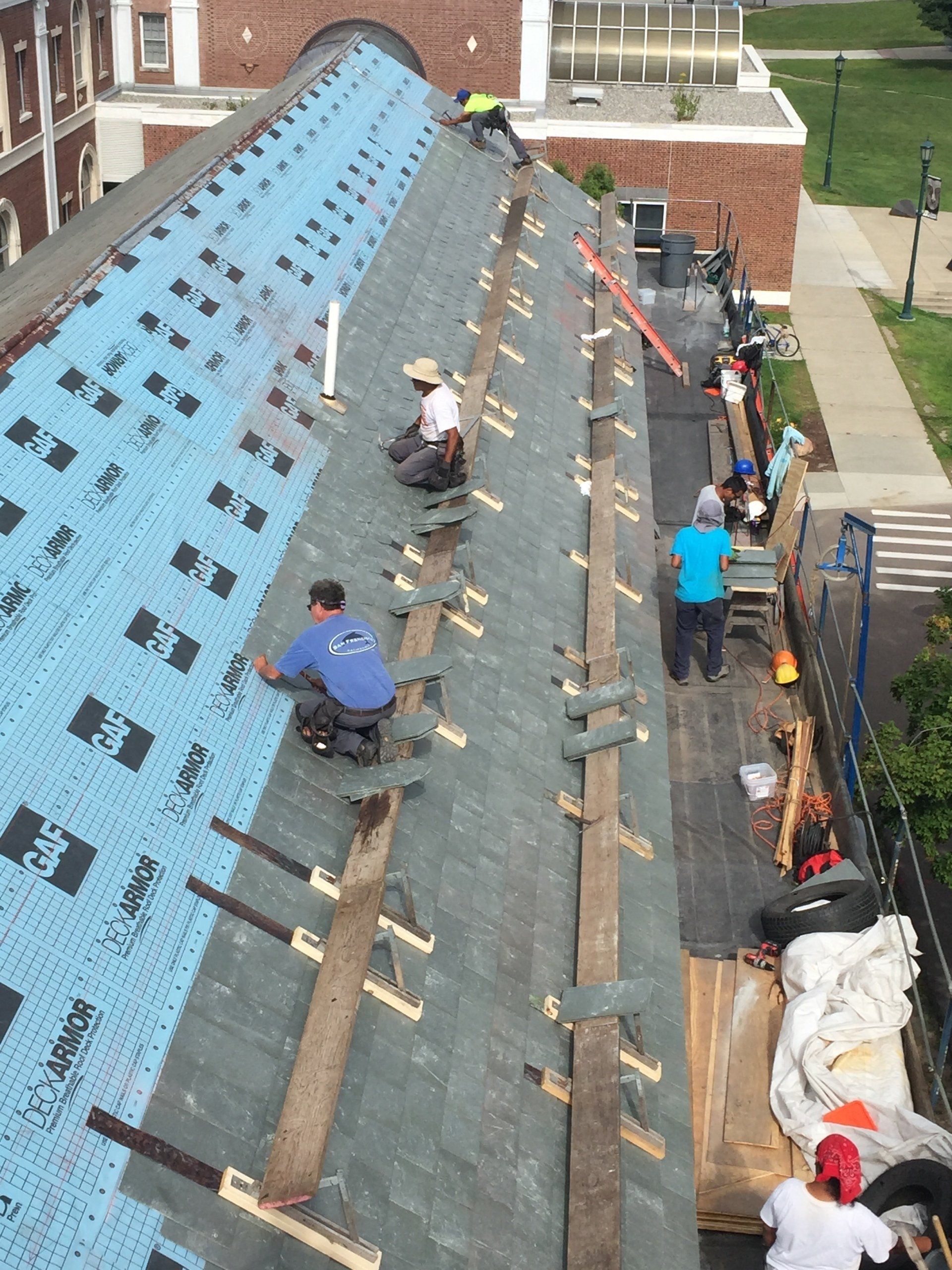 Rodd Roofing crew adding shingles to a new roof