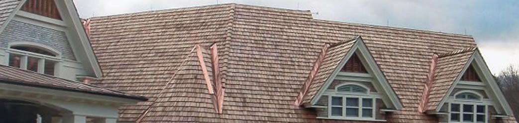 A shingle roof with copper seams, expertly installed by Rodd Roofing, a Vermont roofing company