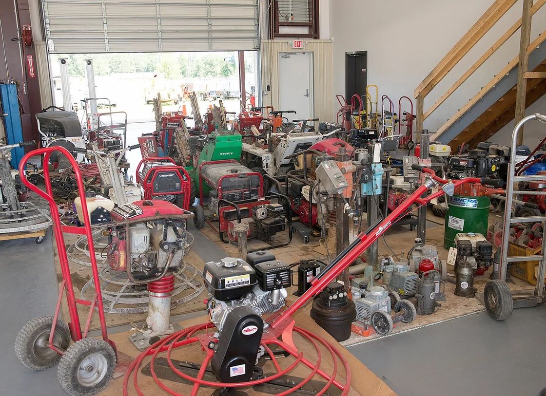 Garage filled with various construction tools and equipment.