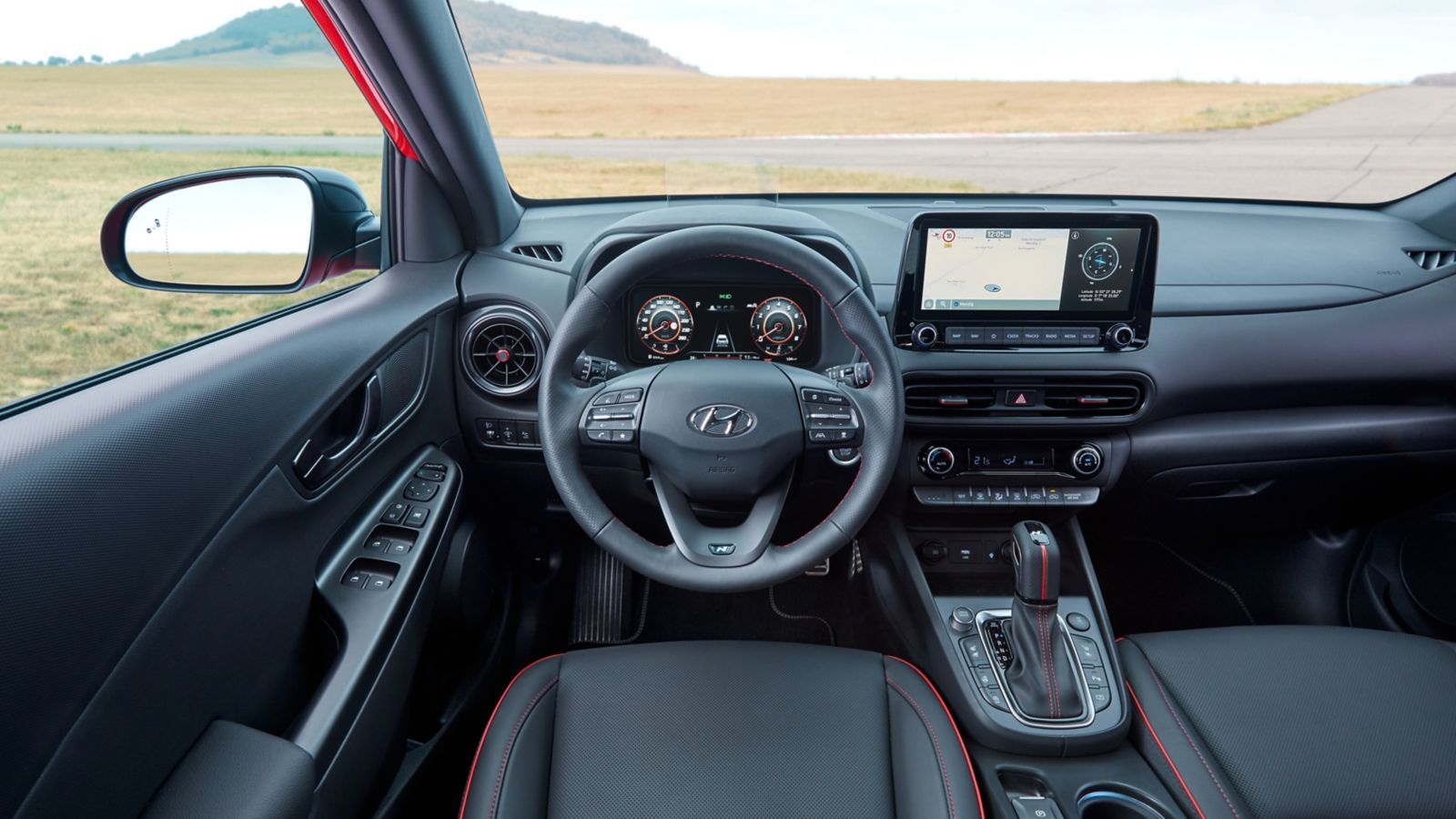 The interior of a hyundai kona is shown with a steering wheel and dashboard.