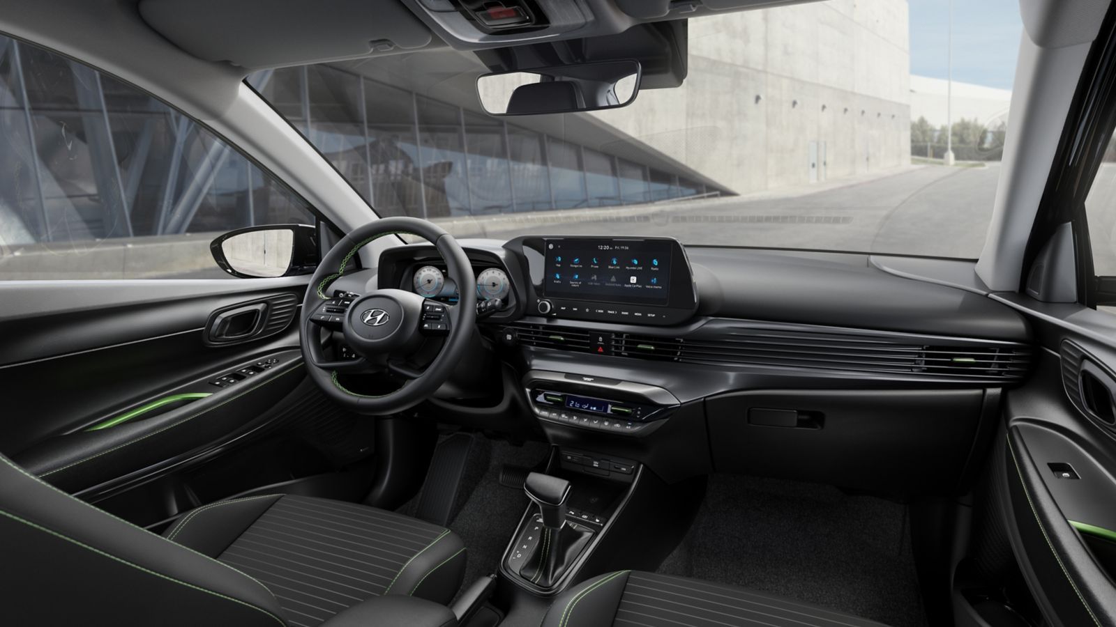 The interior of a car with a steering wheel and a dashboard. i20