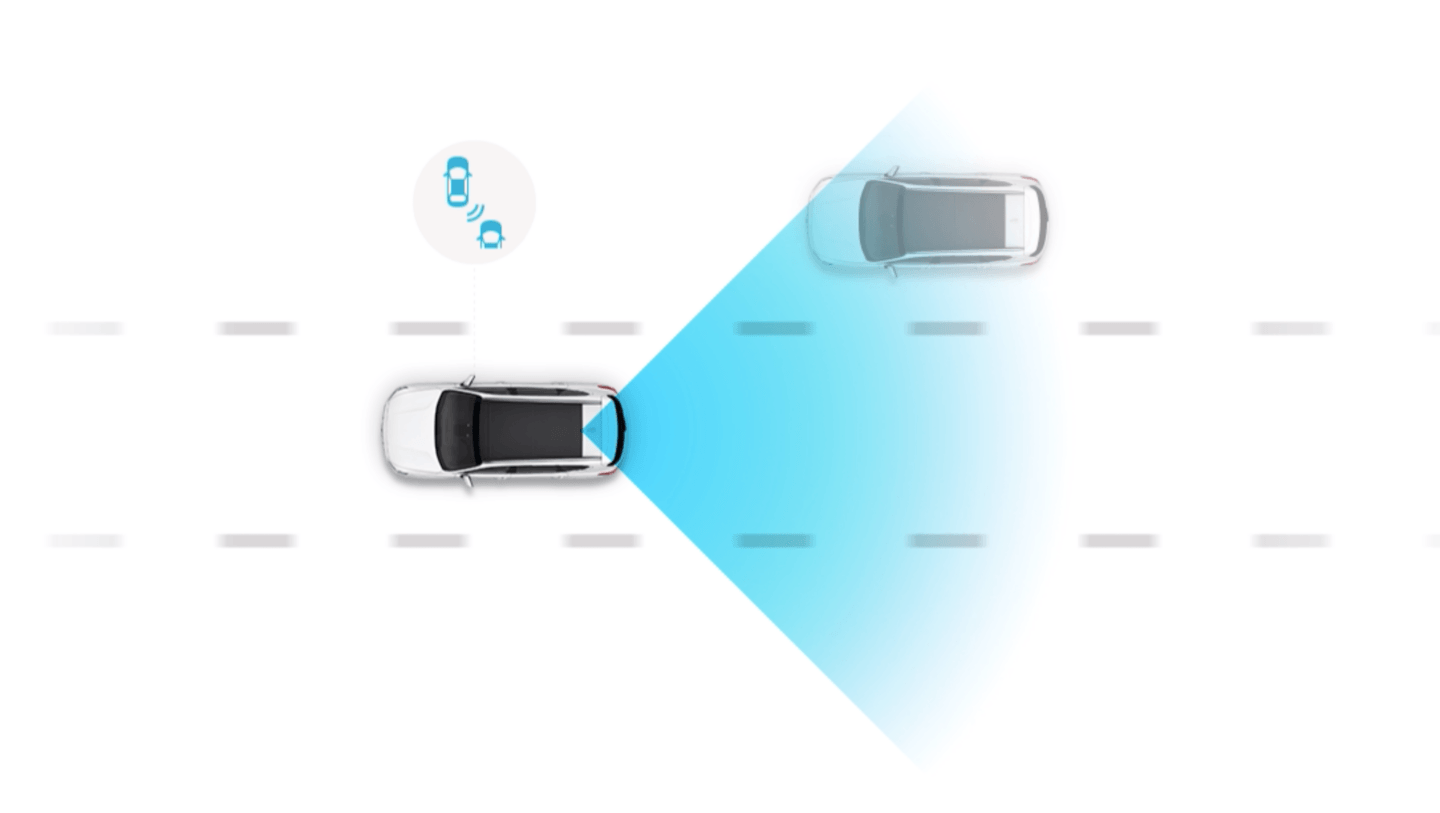 A car is driving down a road next to another car.