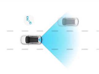 A car is driving down a road next to another car.