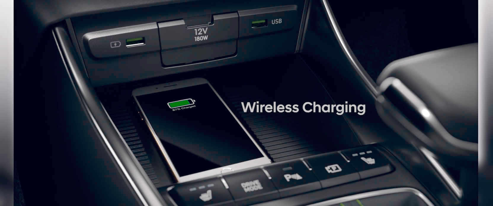 A wireless charging station in the center console of a car.