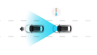 A couple of cars are driving down a road.