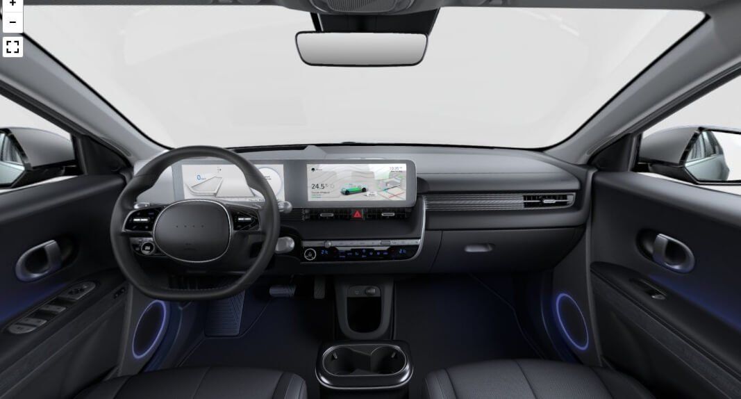 The interior of a car with a steering wheel and a dashboard.