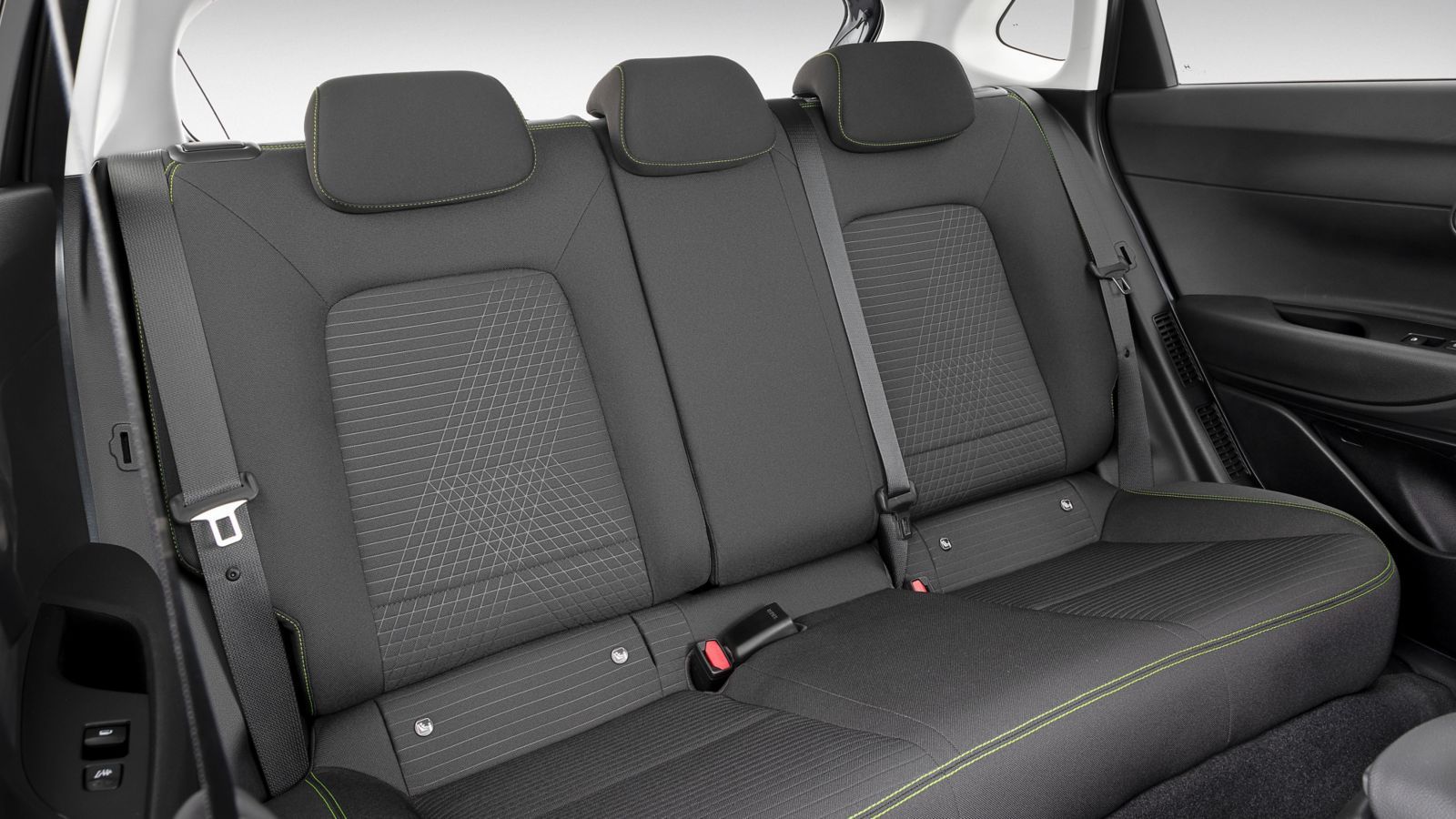 The back seat of a car with a seat belt.