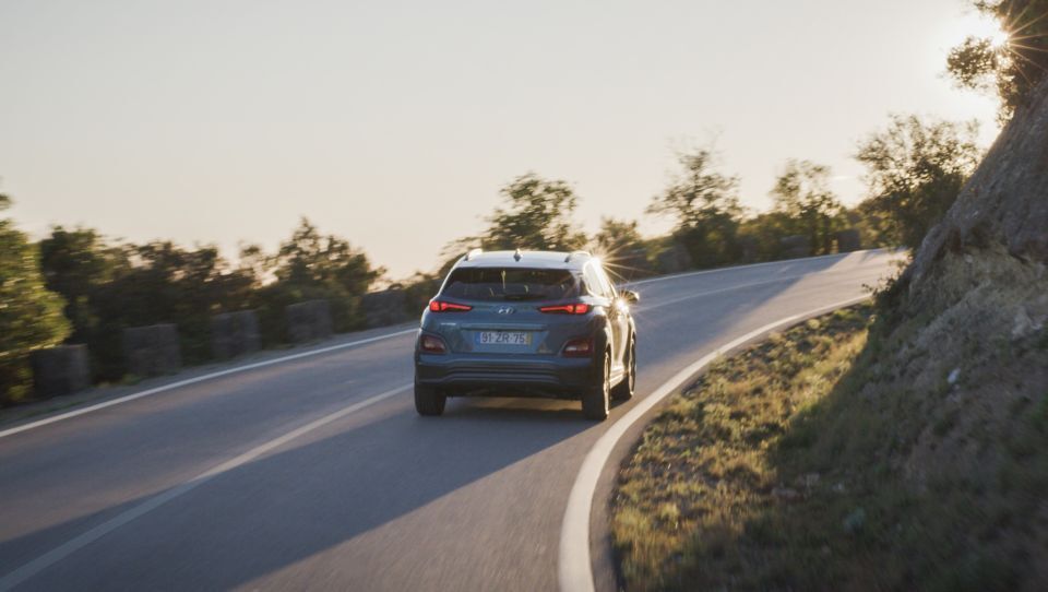 A car is driving down a curvy road.