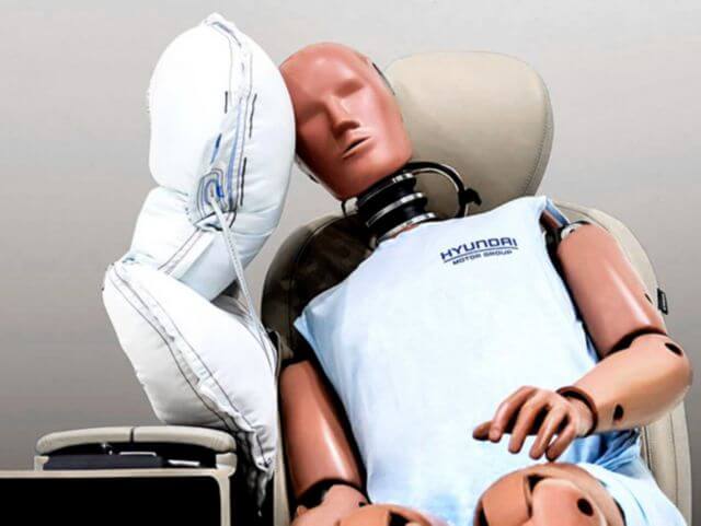 A mannequin wearing a hyundai shirt is laying in a car seat tucson 
