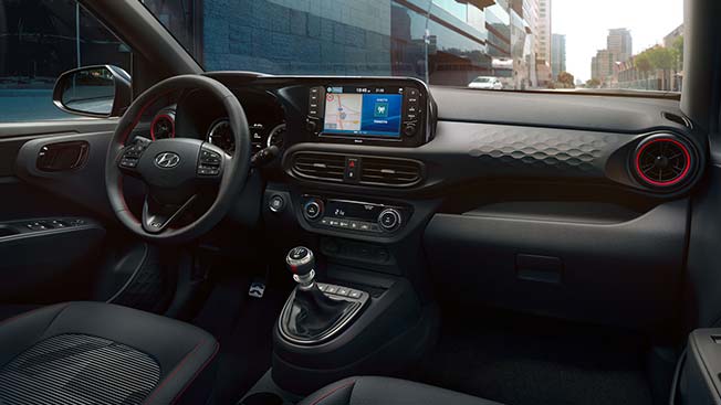 The interior of a car with a steering wheel and a dashboard. I10 N Line