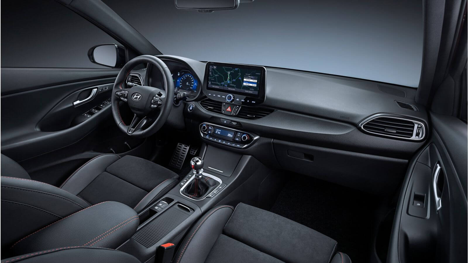 The interior of a car with black seats and a steering wheel.