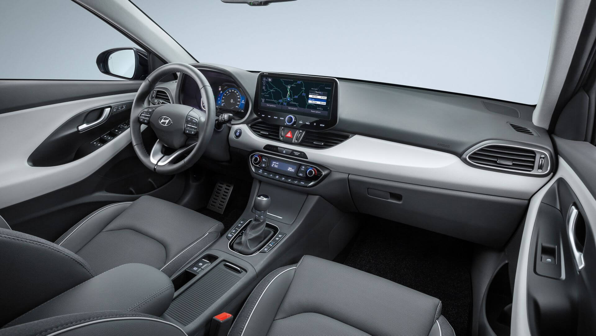 The interior of a car with a steering wheel and dashboard.