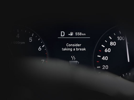 A close up of a car dashboard that says consider taking a break