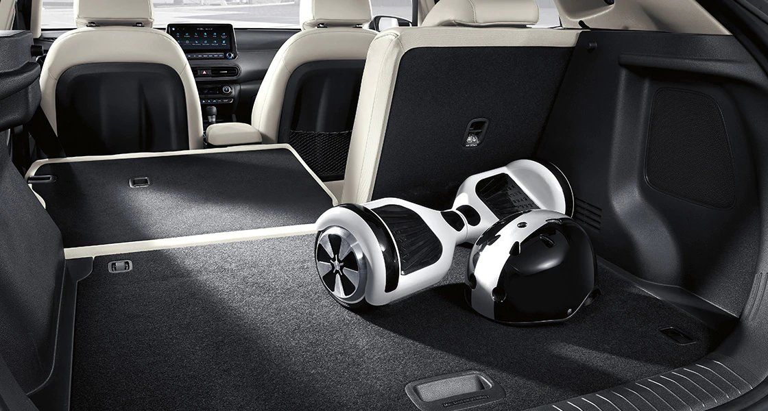 A hoverboard is sitting in the trunk of a car.