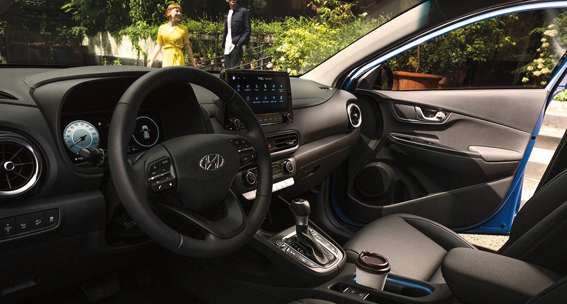 The interior of a hyundai kona with the door open.