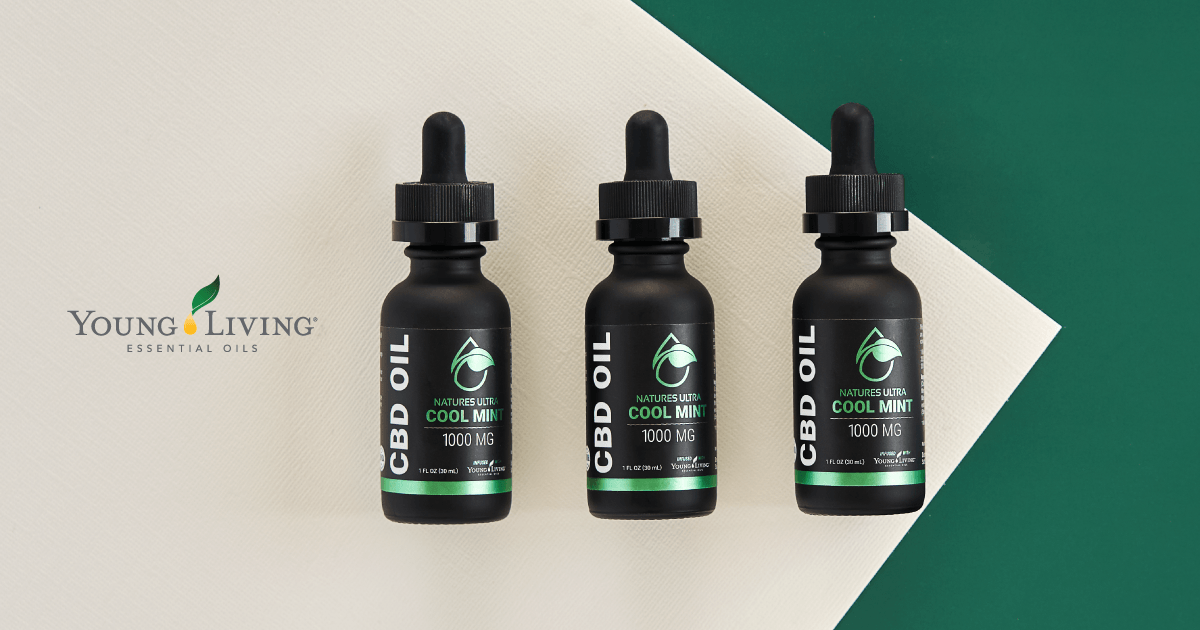 Three bottles of cbd oil are sitting next to each other on a table.