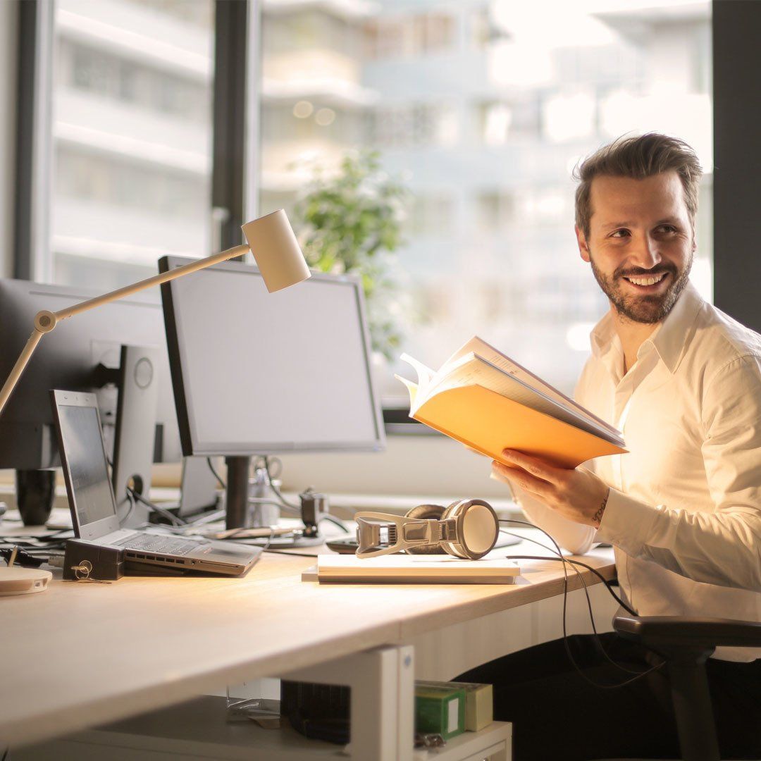 Man Sitting in Front of Computer Smiling