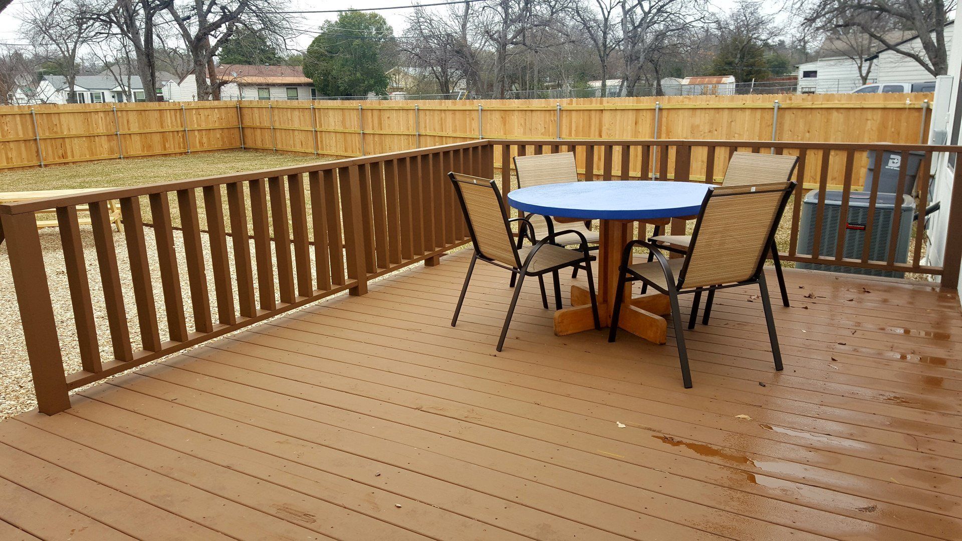 Custom deck build for an exterior living outdoor fire pit project including cedar fence in McKinney Texas
