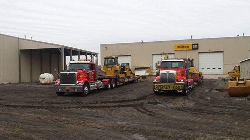 Front of Big Red Towing with two trucks