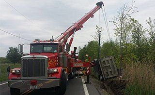 Big Red Truck Towing a Truck - Long Distance Towing in Syracuse, NY Big Red Truck Towing a Truck - Long Distance Towing in Syracuse, NY