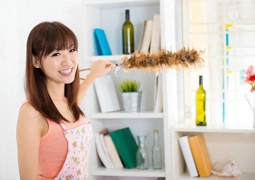 A Woman Cleaning House With Duster — Gilbert, AZ — All State Carpet & Tile Care A Woman Cleaning House With Duster — Gilbert, AZ — All State Carpet & Tile Care