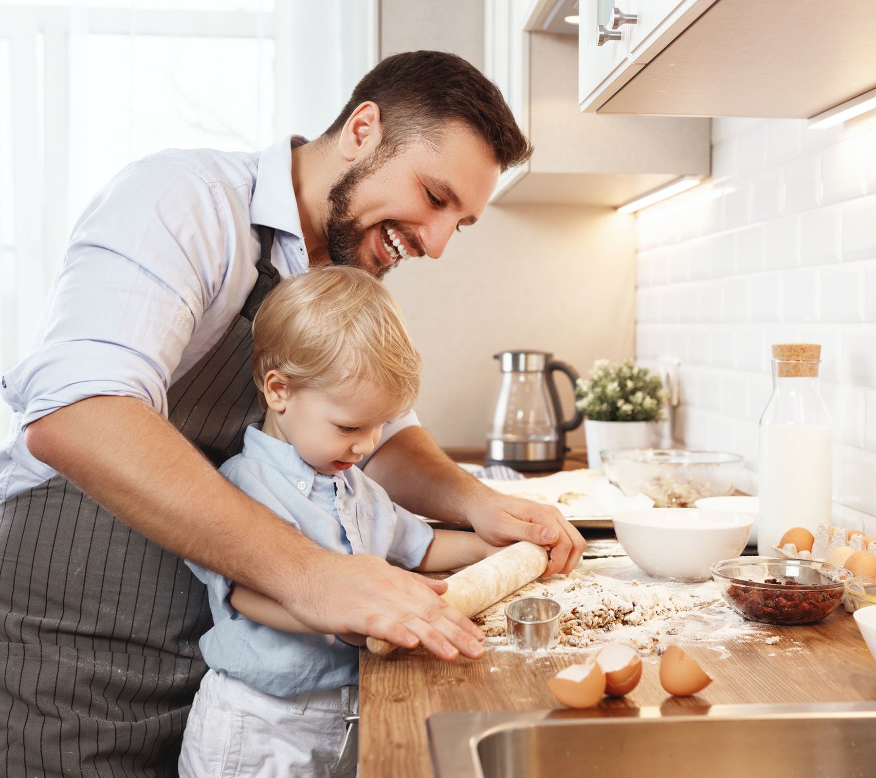 Man cooking with son
