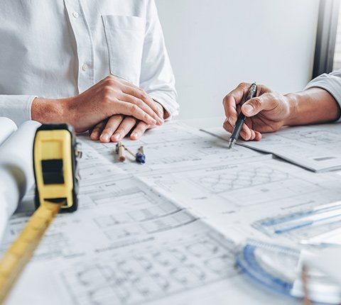 Men Working On A Blueprint — Marietta GA — Quantum Installation Group