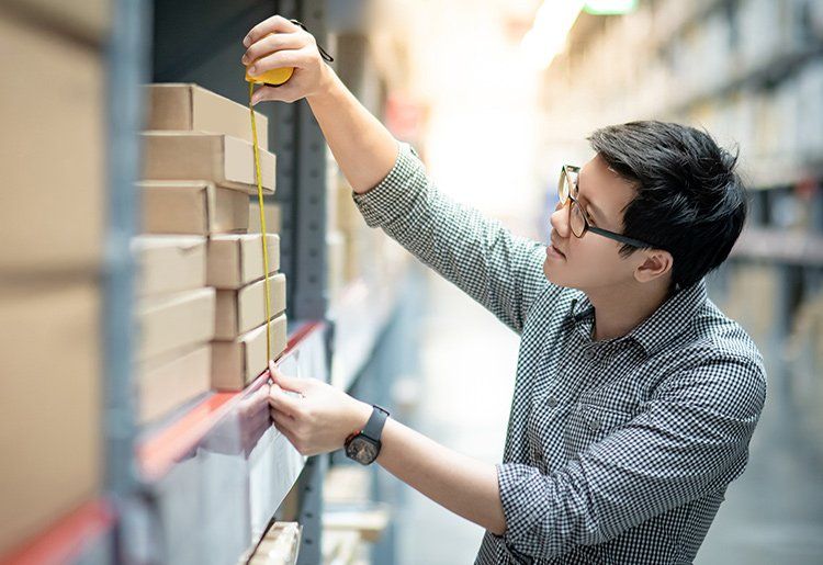 Man Measuring Shelf — Marietta GA — Quantum Installation Group