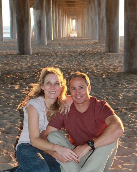 Mission Beach Airbnb Hosts A man and a woman are posing for a picture under a pier