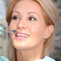 Cleaning - Woman having her teeth checked in Erie, PA