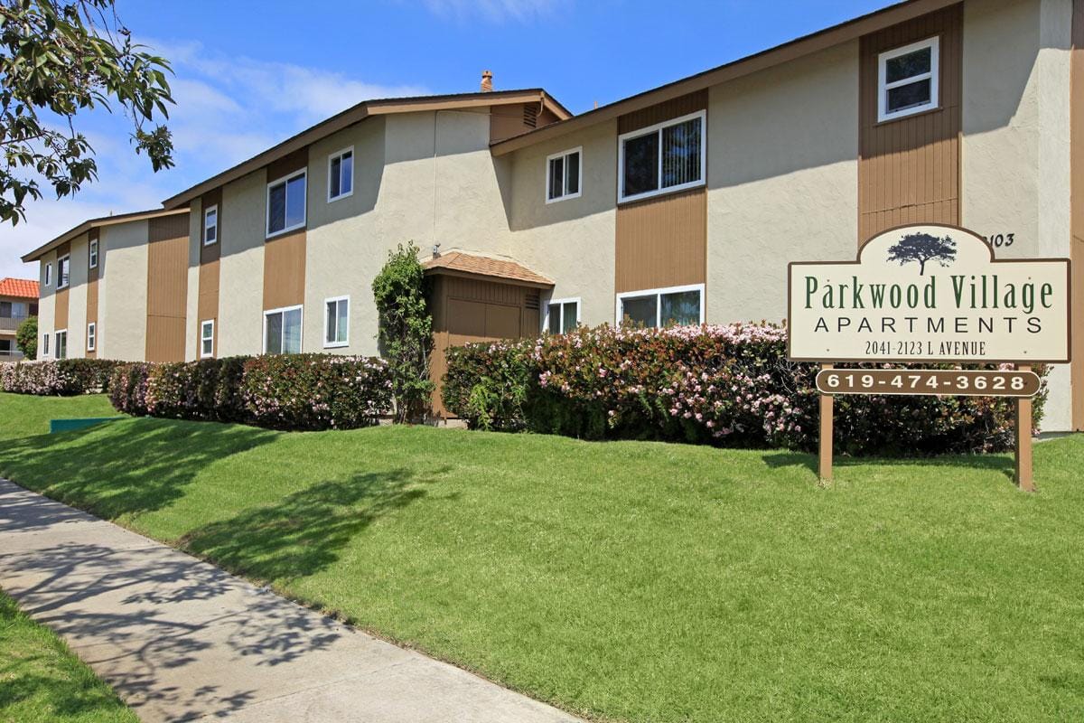 Parkwood Village Apartments sign in front of apartment building