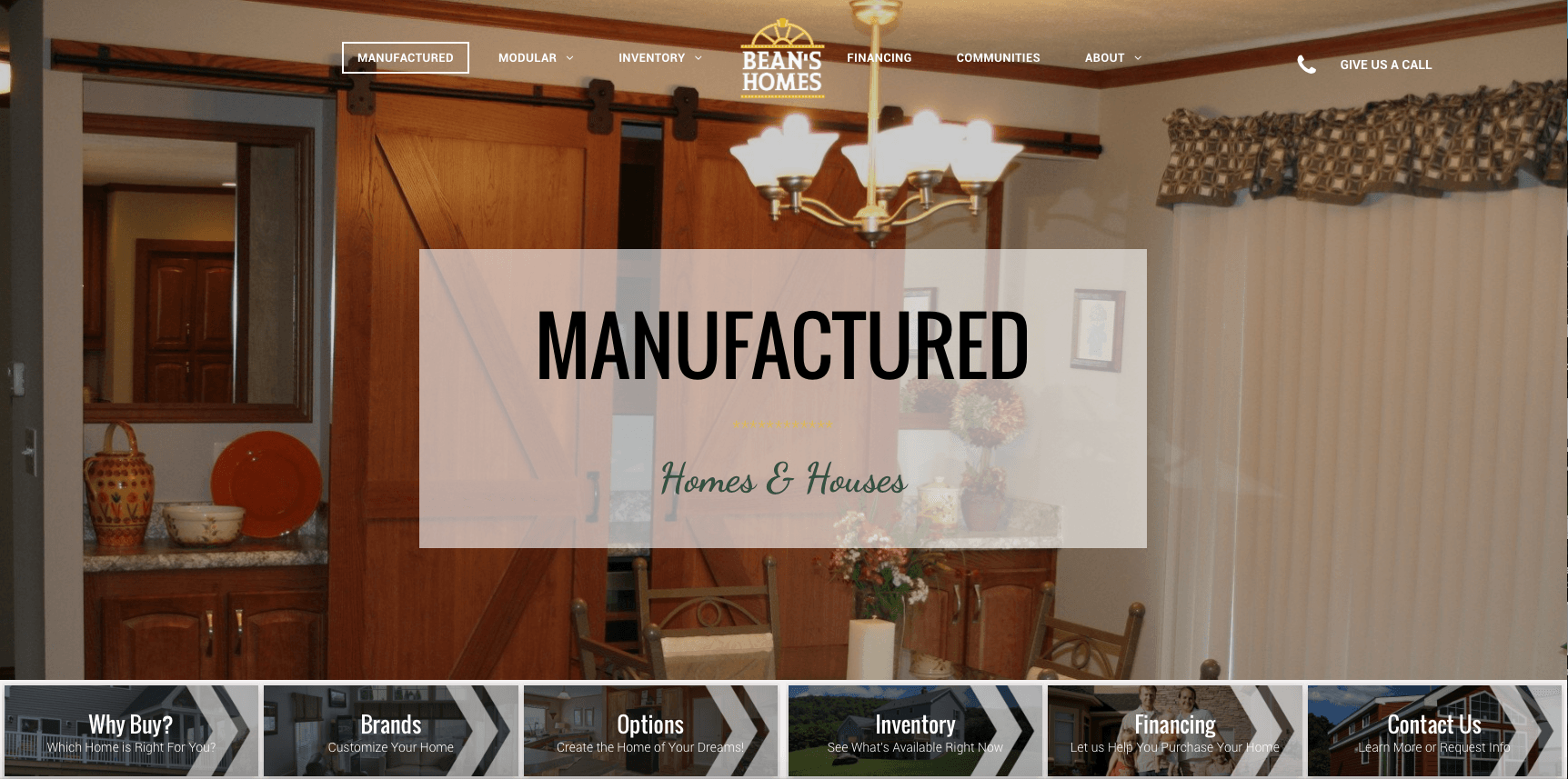 Interior of a manufactured home, showcasing a barn door and dining area.