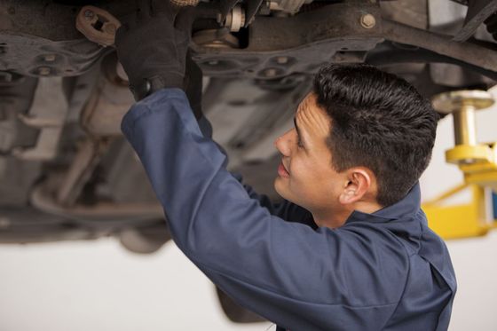 Mechanic works on a car