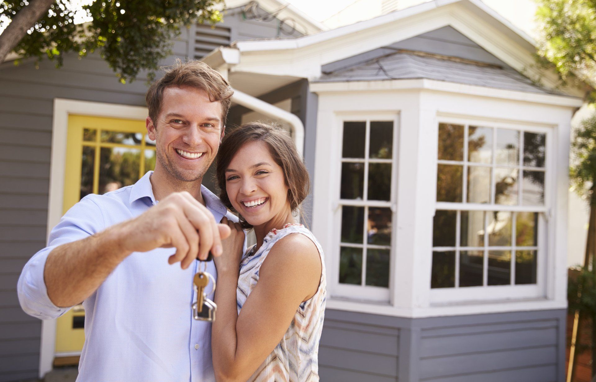 A couple holding the keys of their new house. Discover Homes for Sale in Greenhaven-Pocket with Catricala Real Estate Group