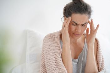 woman rubbing her head