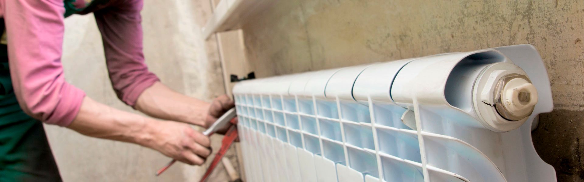 Technician installing a radiator