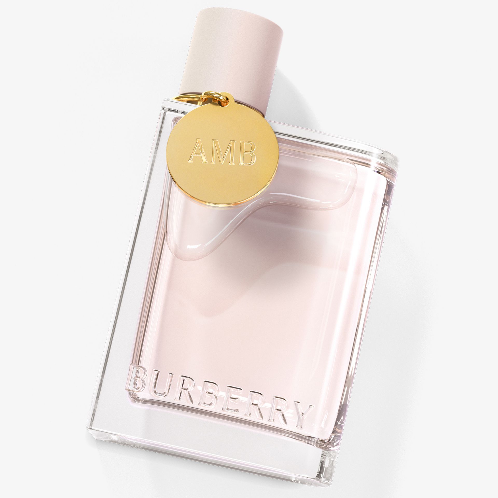 Burberry rosa Il suo flacone di profumo con ciondolo dorato.