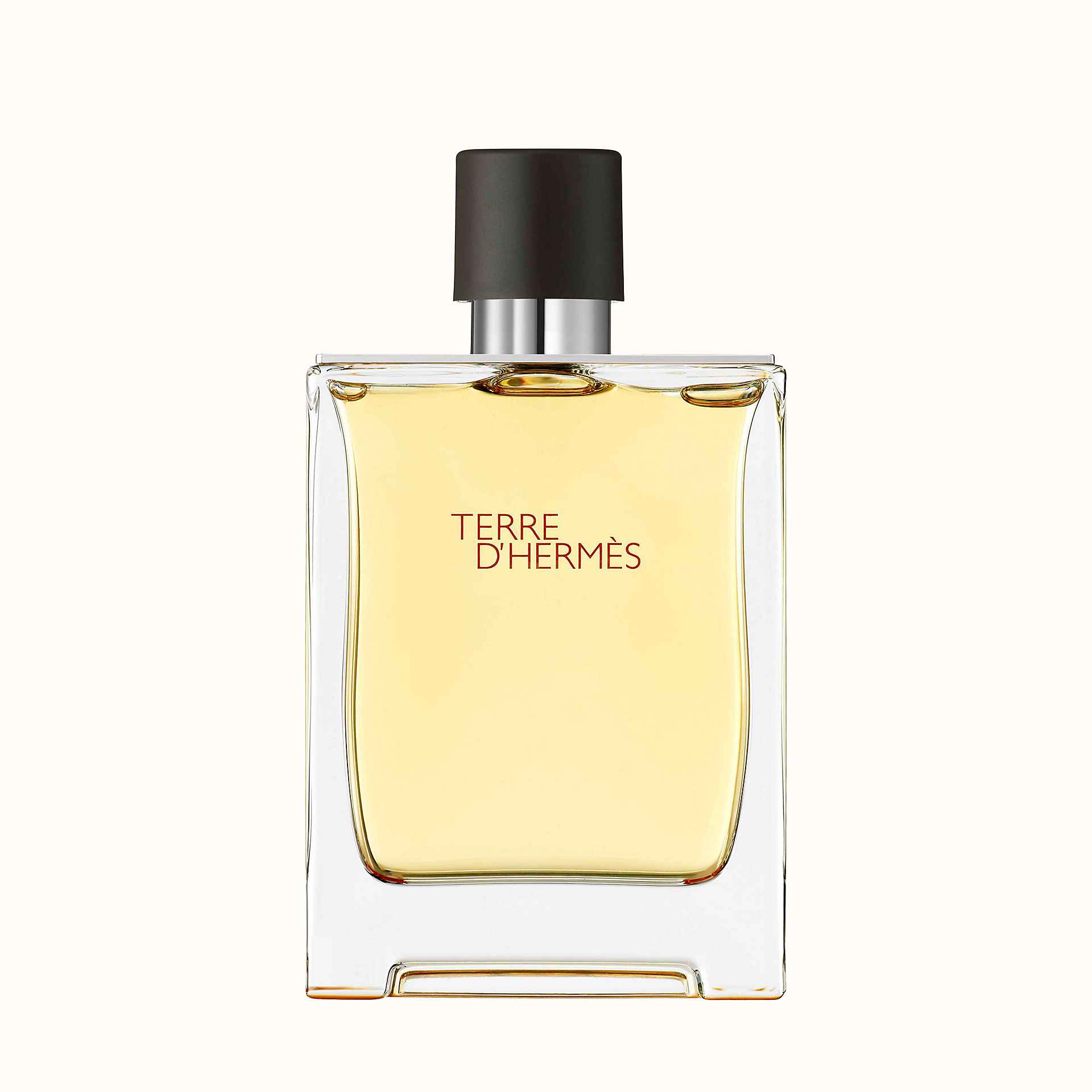 Flacone di colonia da uomo Terre d'Hermès. Vetro rettangolare con tappo marrone scuro e scritta arancione.