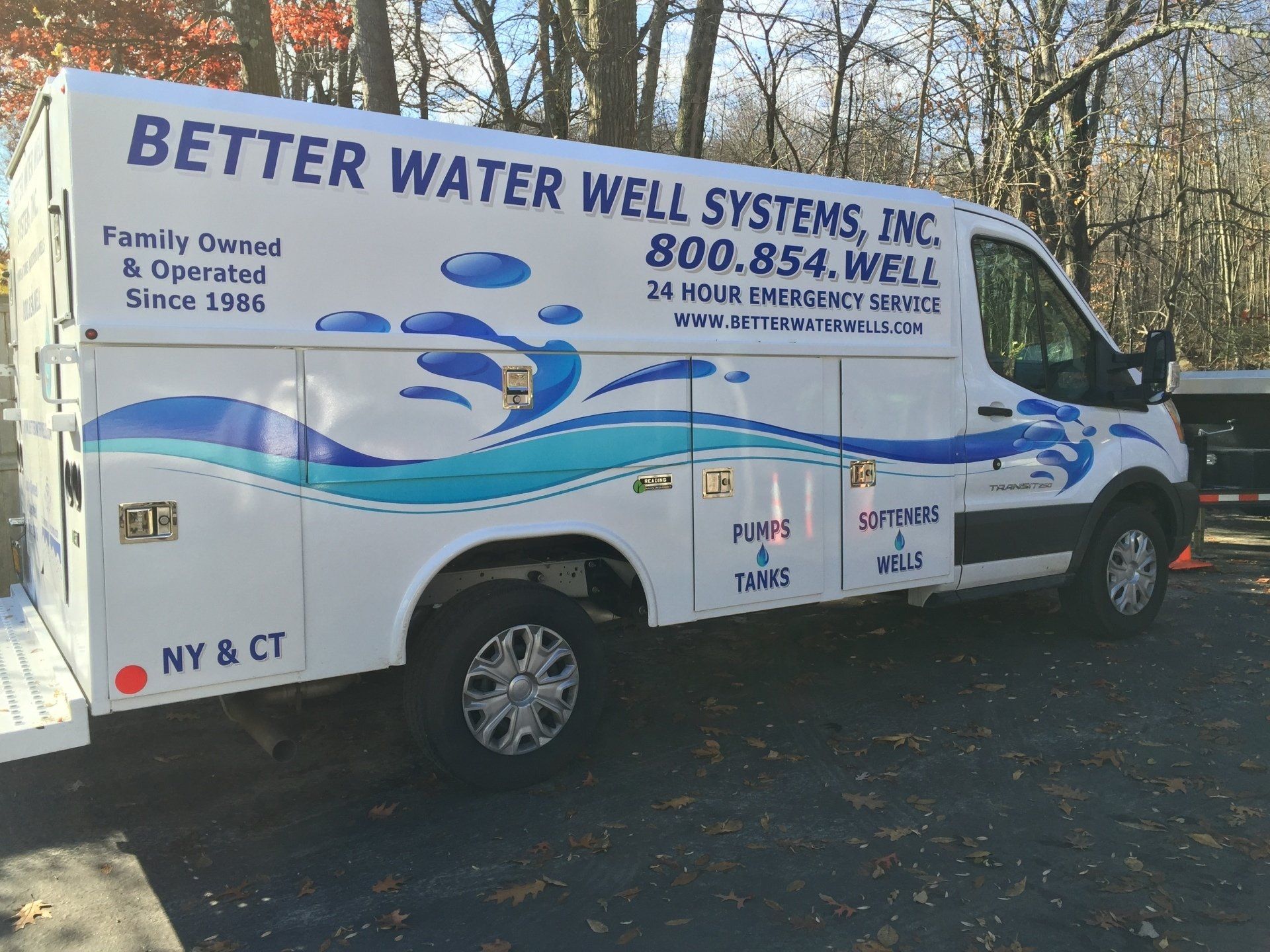 White service van for Better Water Well Systems, Inc. with blue water graphics, contact info, and 