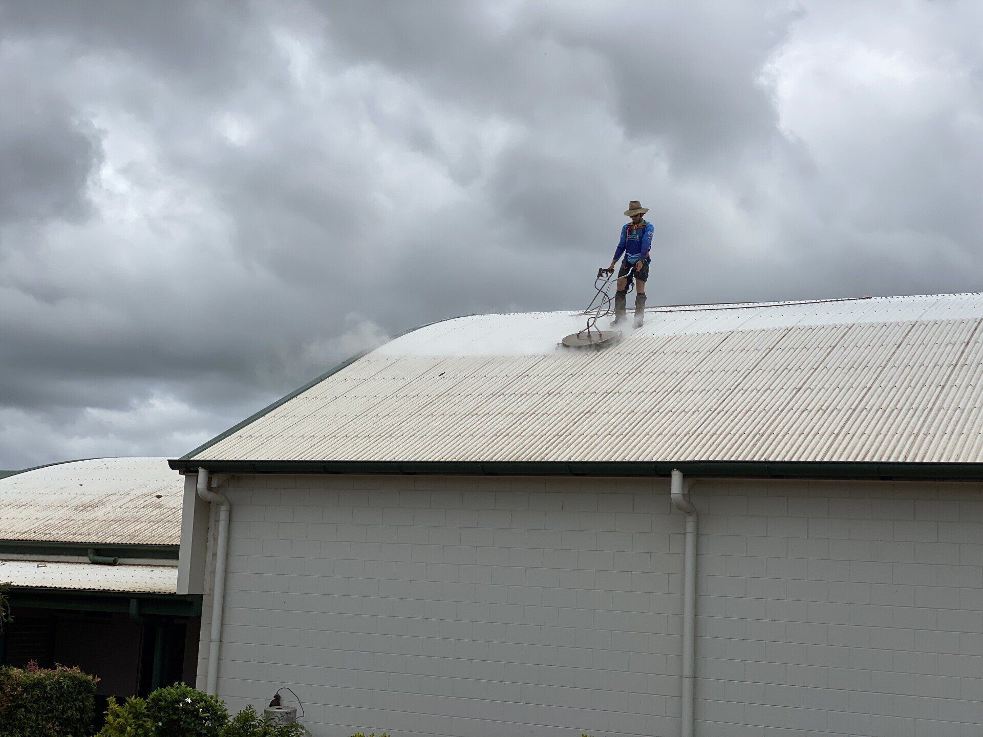 Man Cleaning The Roof — FNQ Pressure Cleaning in Atherton, QLD