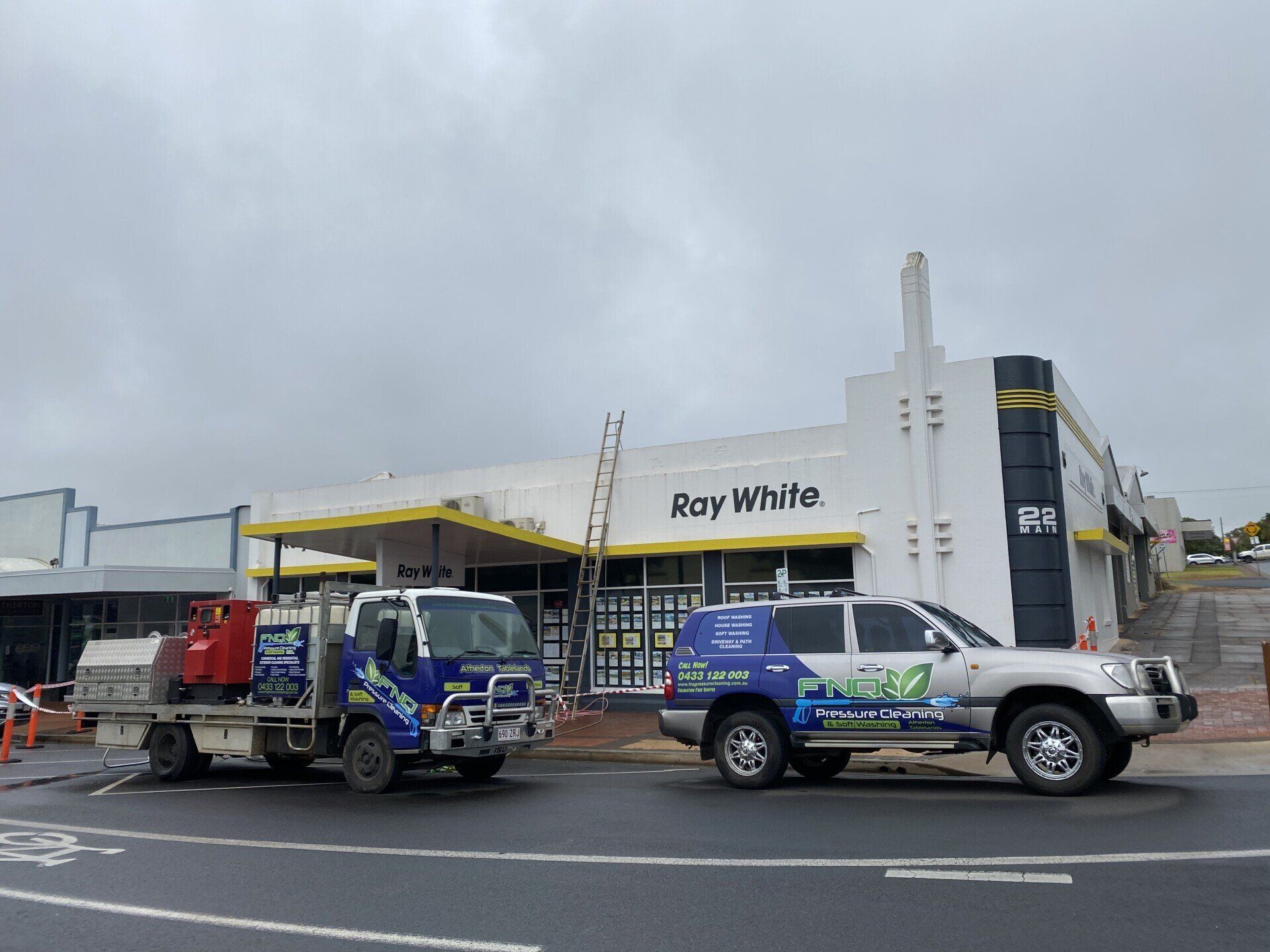 Two Vehicles In Front Of The Ray White Building — FNQ Pressure Cleaning in Atherton, QLD