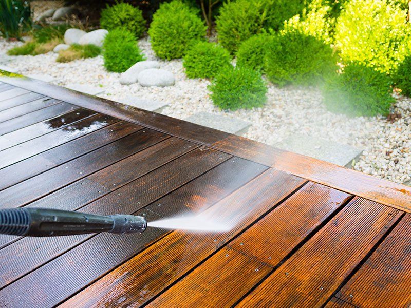 Cleaning Terrace with a Power Washer — FNQ Pressure Cleaning in Atherton, QLD Cleaning Terrace with a Power Washer — FNQ Pressure Cleaning in Atherton, QLD