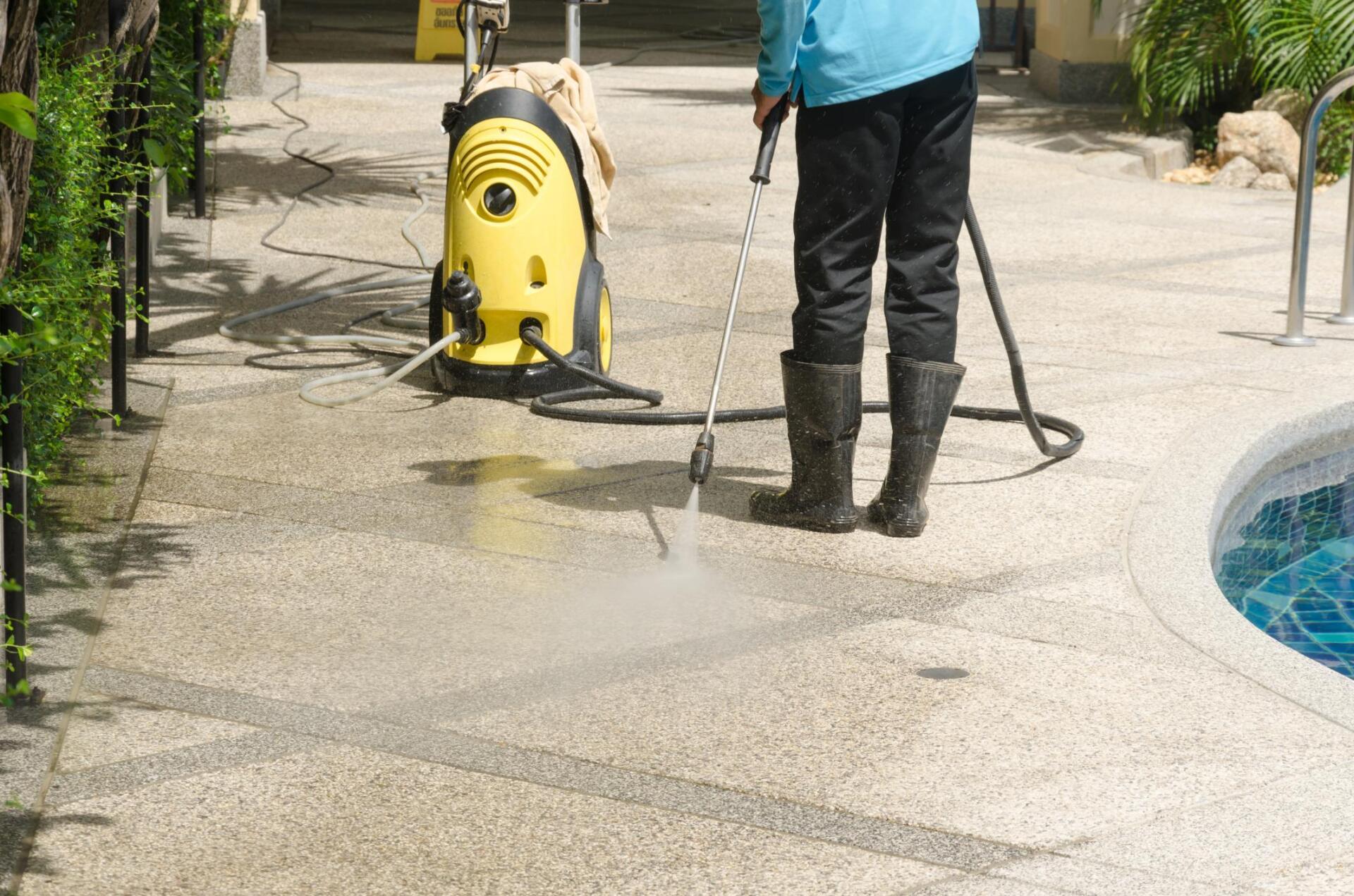man using pressure washer